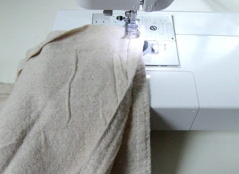 Two pieces of drop cloth being sewn together on a sewing machine
