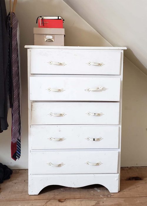 worn dresser with crooked drawers and broken handles